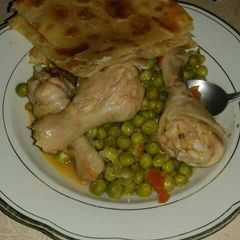 A picture of Chicken stew and peas.