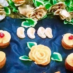 A picture of Orange cup cakes with orange flowers decorate.