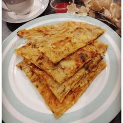 A picture of ALOO kAY PARATHAY WITH KETCHUP AND TEA.