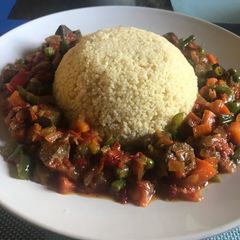 A picture of Cous cous with liver sauce.