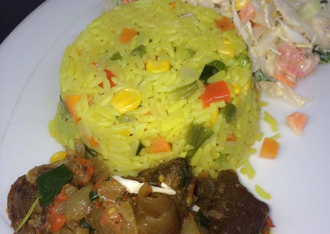 Fried rice with peppered goat meat and coleslaw