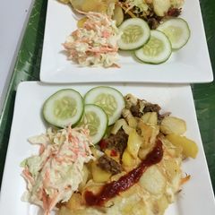 Sweet and spicy Potatoes Fiesta garnish with coleslaw and ketchup drizzle A picture of Sweet and spicy Potatoes Fiesta garnish with coleslaw and ketchup drizzle.