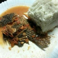 A picture of Stewed fish served with Ugali.