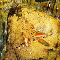 A picture of Rohu fish in banana leaf.