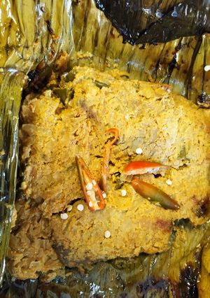 A picture of Rohu fish in banana leaf.
