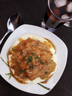 A picture of Piccata chicken sauce with mashed potatoes.
