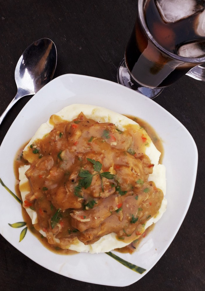 A picture of Piccata chicken sauce with mashed potatoes.