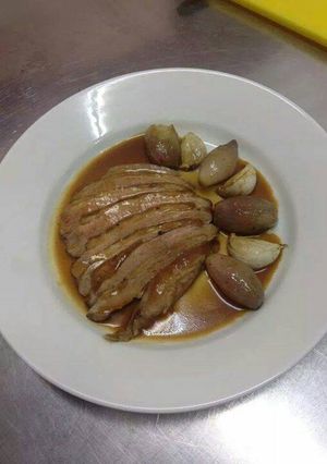 A picture of Duck breast with caramelized shallots and roasted garlic.