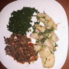 A picture of Plantain served with spinach and tripes.