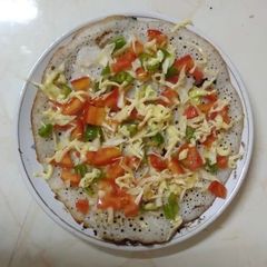 A picture of Tomato, cabbage, capsicum jain uttapam.