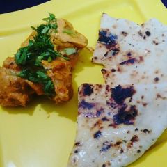 A picture of Chicken Tikka Masala with Garlic Naan bread.