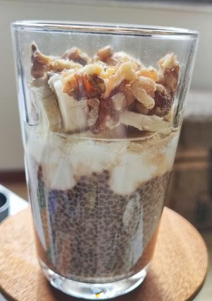 A picture of Vanilla-Scented Coffee Chia Pudding with Greek Yogurt, Banana, and Walnuts.