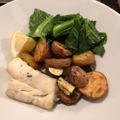A picture of Baked Cod, potatoes and courgette with winter greens.