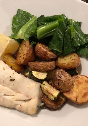 A picture of Baked Cod, potatoes and courgette with winter greens.