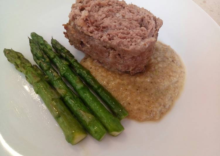 Meatloaf with prosciutto, porcini sauce and pan fried asparagus
