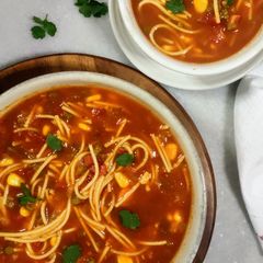A picture of Tomato Vegetable Noodle soup.