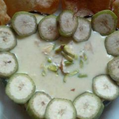 A picture of Janmashtami RAW BANANA KHEER And RAJGARA PURI.
