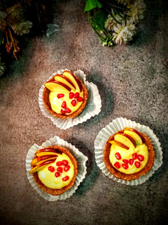 A picture of Date tart with mango cream and fruits.