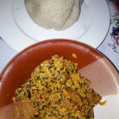 A picture of Egusi soup with White Garri (Eba).