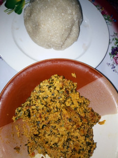 A picture of Egusi soup with White Garri (Eba).