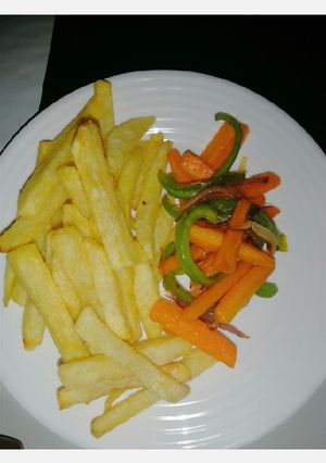 A picture of Fries and stir fry veges.