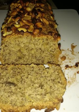 A picture of Banana bread with nuts and chocolate chips toppings..