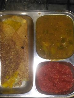 A picture of Masala Dosa with chutney.