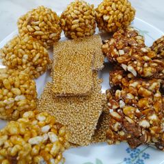 Peanut sessmme chikki and rice puff ladoo A picture of Peanut sessmme chikki and rice puff ladoo.