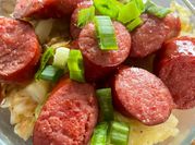 A picture of fried cabbage and sausage