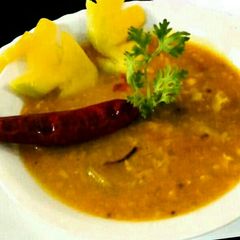 A picture of Masoor daal with raw mango.