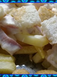 Una foto de Papas fritas con salsa y crutones