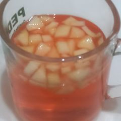 A picture of Rooh afza with apple chunks 🍎.