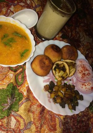 A picture of New Version Of Roti And SabziStuffed Aloo Bhindi in cooker with Mogra Dal And Masala Chaas.