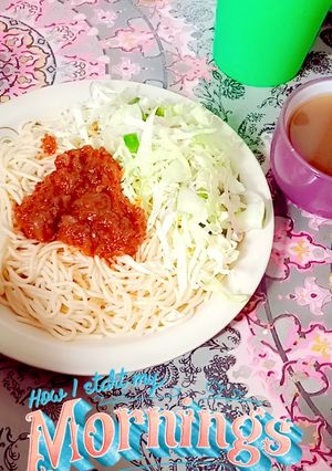 A picture of Sphagetti and vegetables with spiced tea.