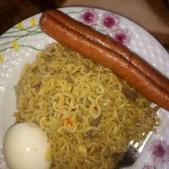 A picture of Indomie with egg & sausage.