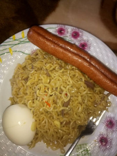 A picture of Indomie with egg & sausage.