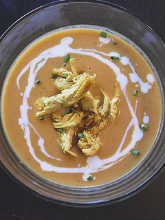 A picture of Butternut squash and curry soup with chicken.