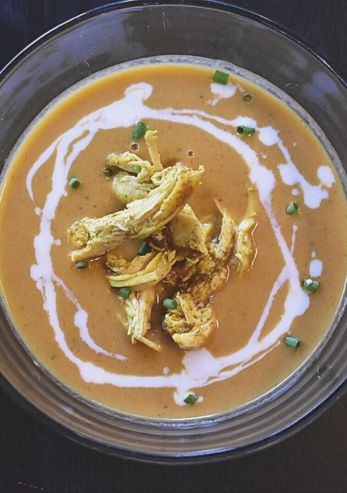 A picture of Butternut squash and curry soup with chicken.