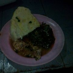 A picture of Wet fried chicken with mrenda and ugali.