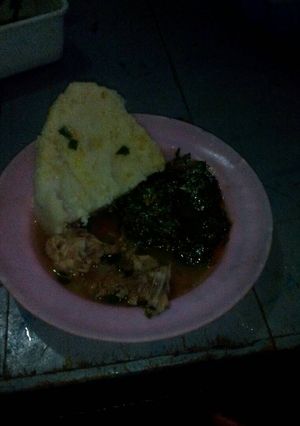 A picture of Wet fried chicken with mrenda and ugali.