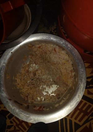 A picture of Mixture of rice and tomatoes.