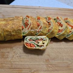 A picture of Egg rolls with veggies.