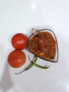 A picture of Quick tamatar kalaunji subji (tomato curry).