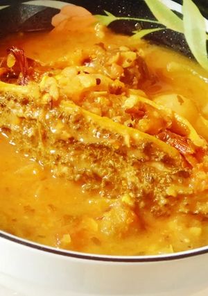 A picture of Spicy aromatic nutritious stuffed bitter gourd in tomato sauce.
