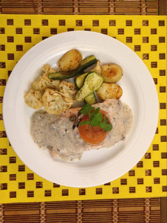 A picture of Salmon poached in mushroom cream.