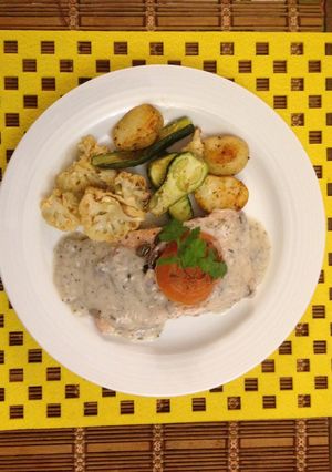 A picture of Salmon poached in mushroom cream.