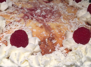 A picture of White Chocolate Raspberry Cheesecake w/ Oreo Crust.