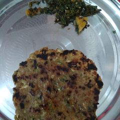 A picture of Bajra Parantha with aalo bathua Sabzi.