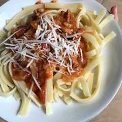 A picture of Bolognese homemade akyuh on top of fettucine.