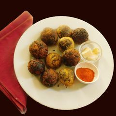 A picture of Spicy kuzhi appam stuffed with Paneer.